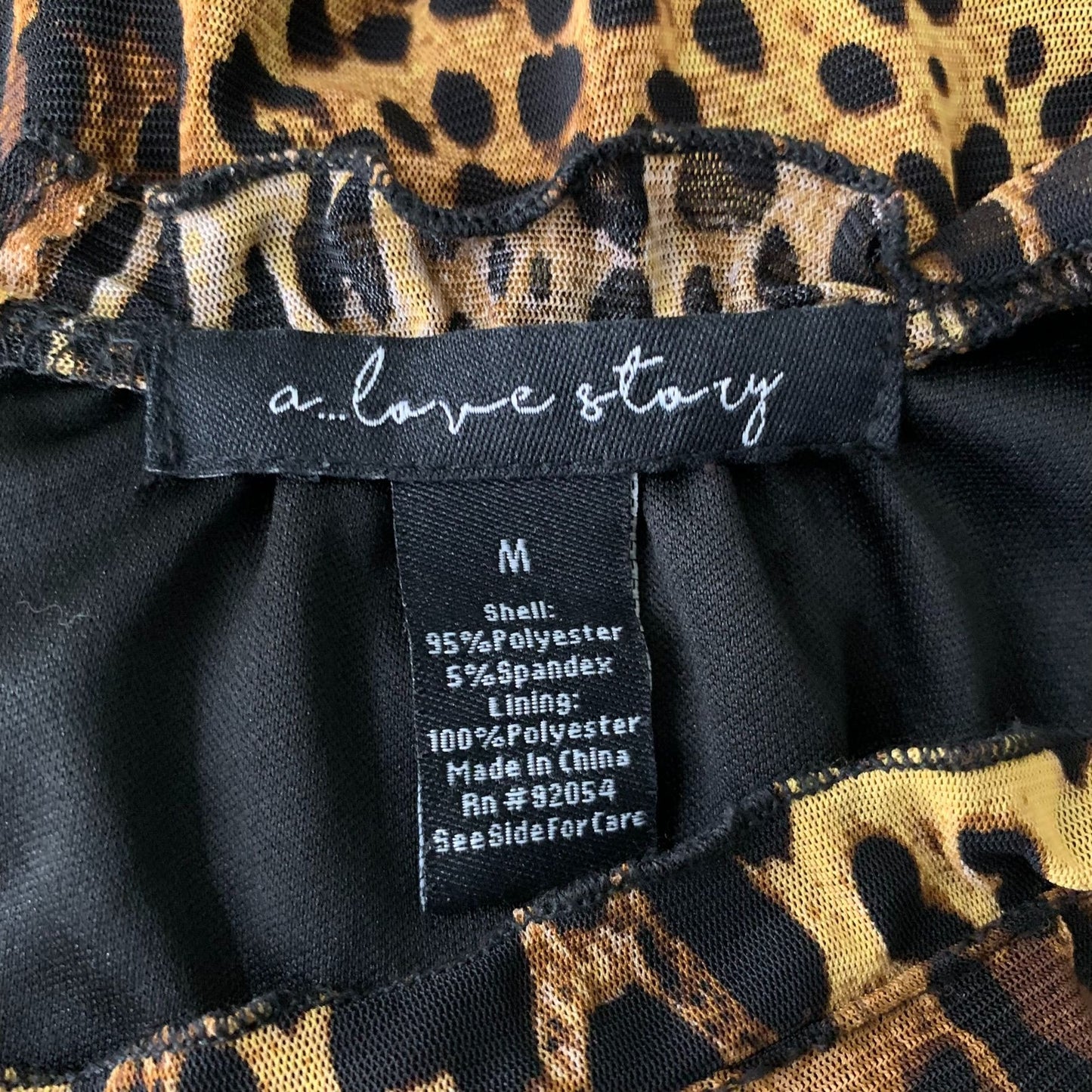 A Love Story Short Sleeve Peplum Top M Leopard Print Stretch Knit Lined Keyhole